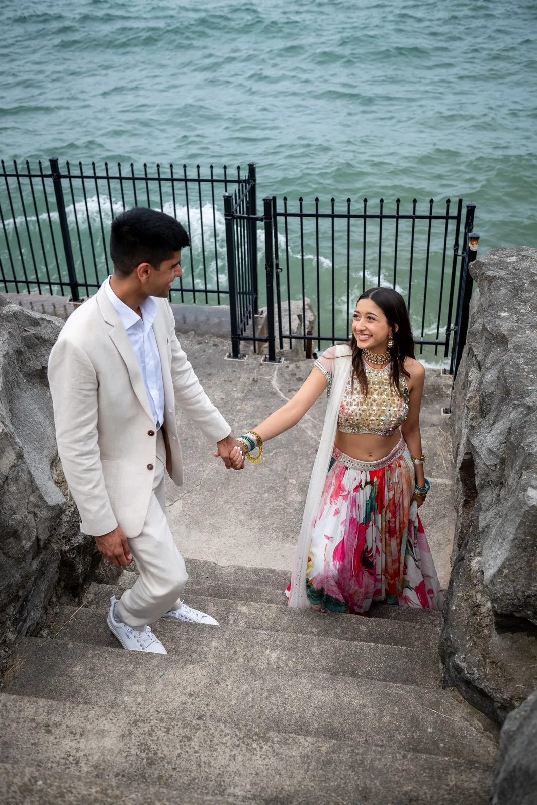 Kunal and Alisha looking at one another on stone steps